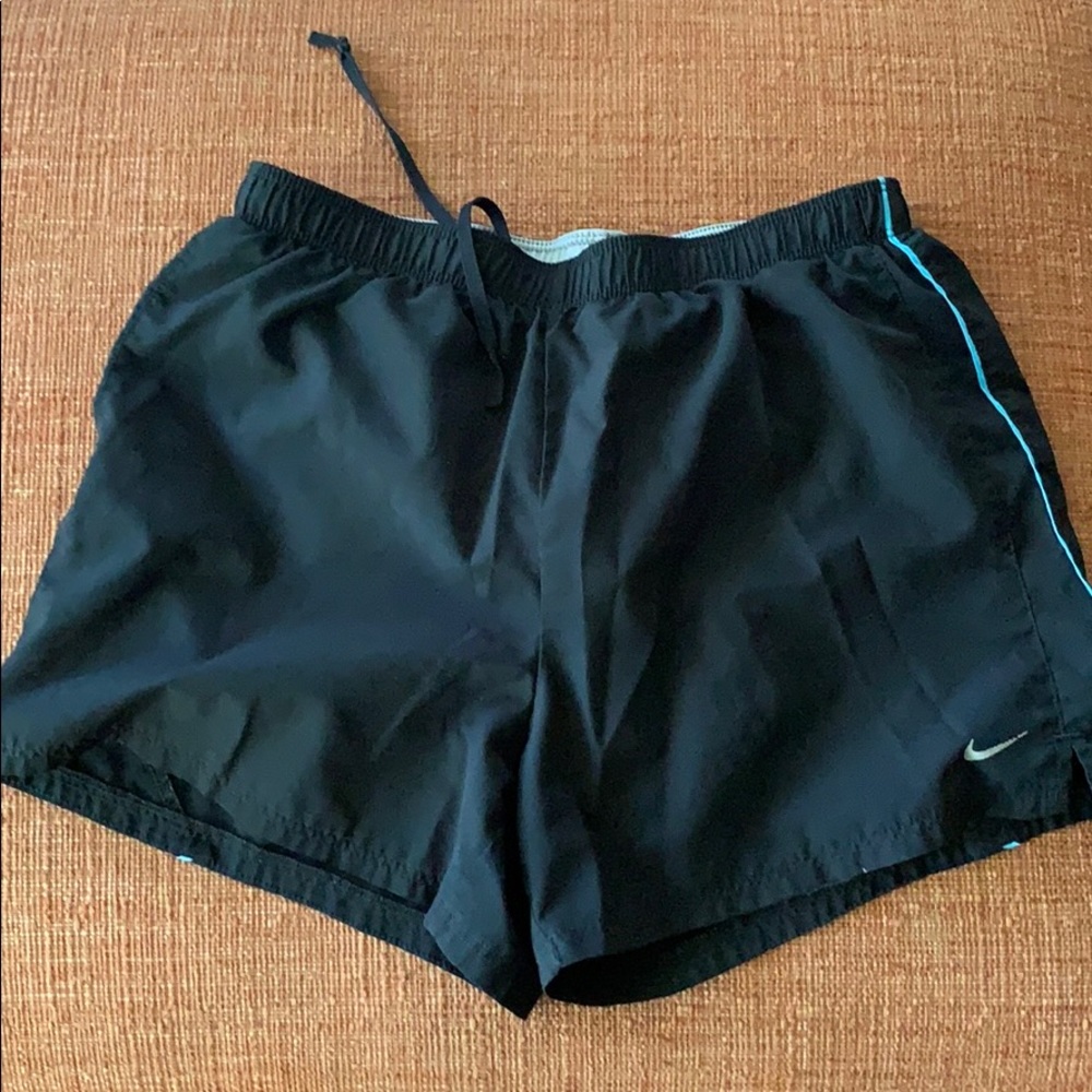 Black women’s Nike shorts with blue stripe